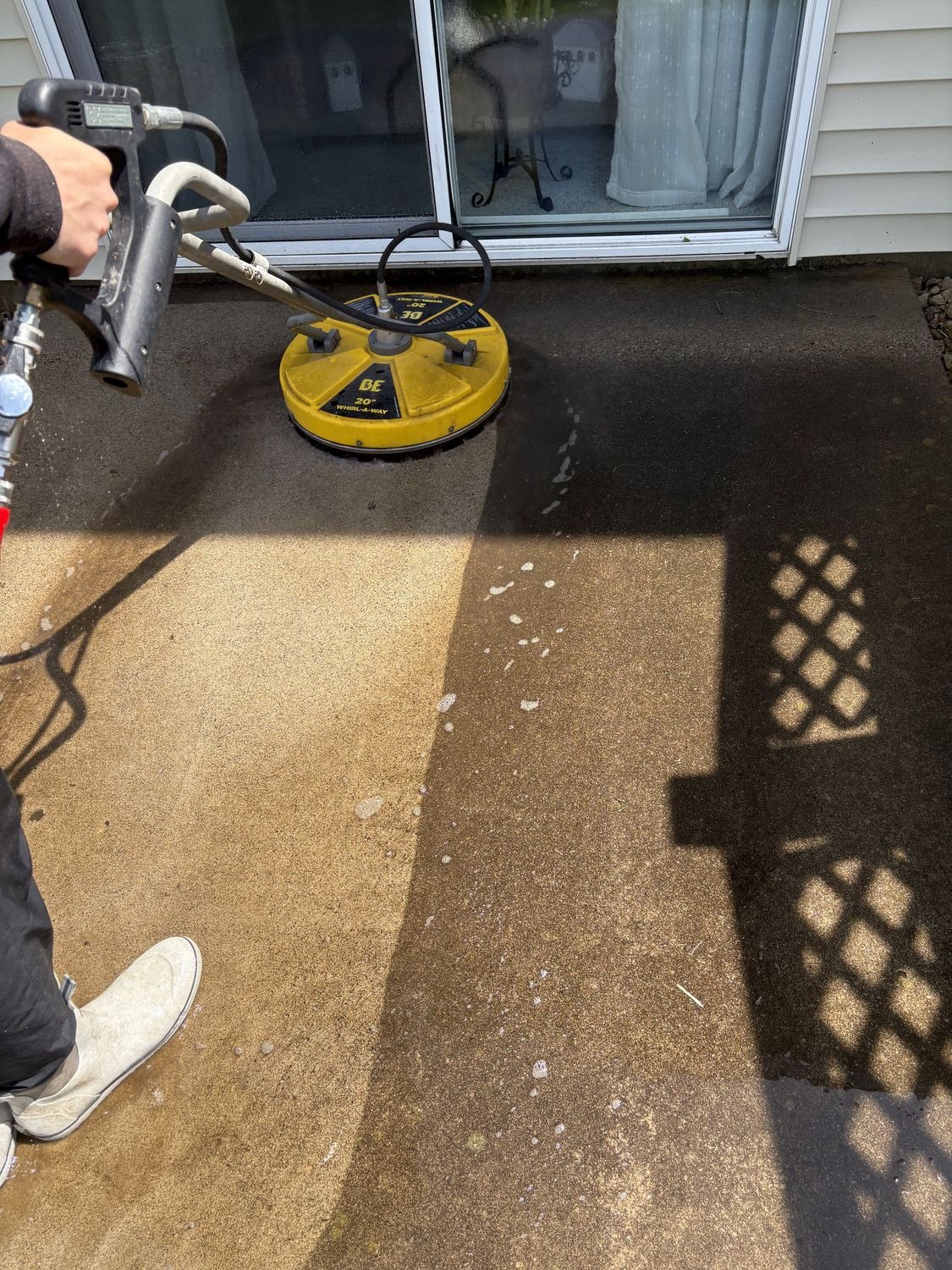 Pressure washing a concrete patio with a surface-cleaner attachment